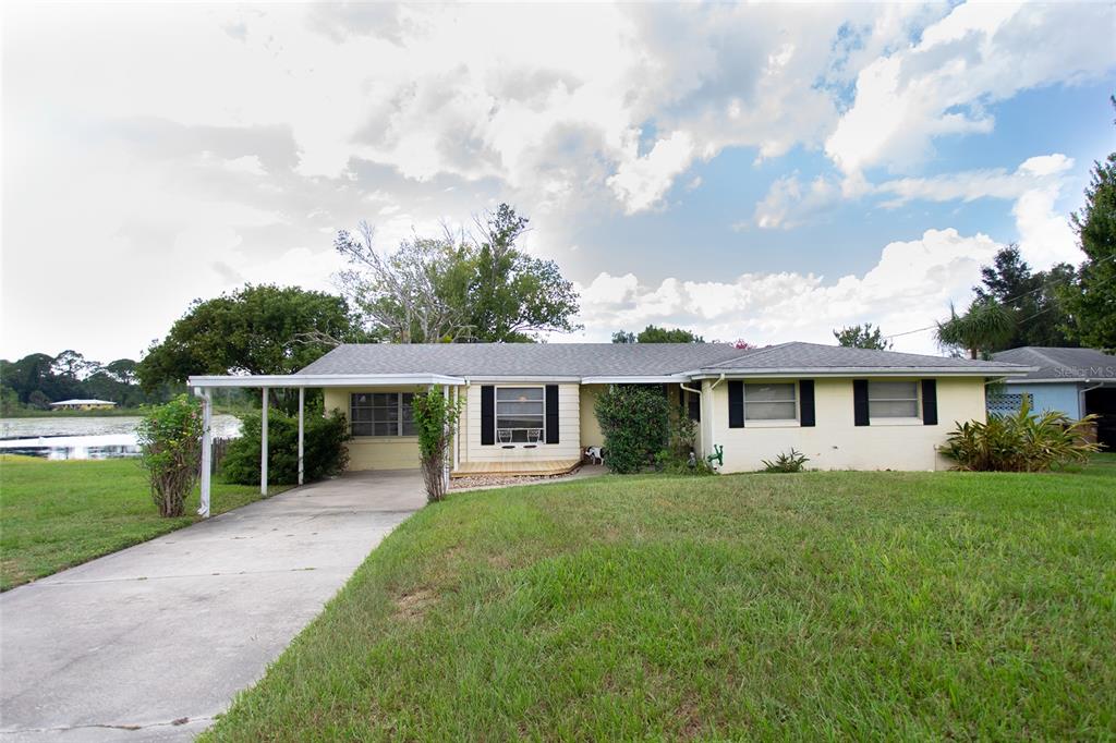 a front view of house with yard and green space