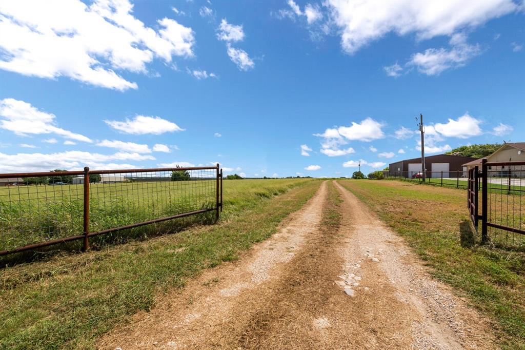 a view of a pathway with a yard