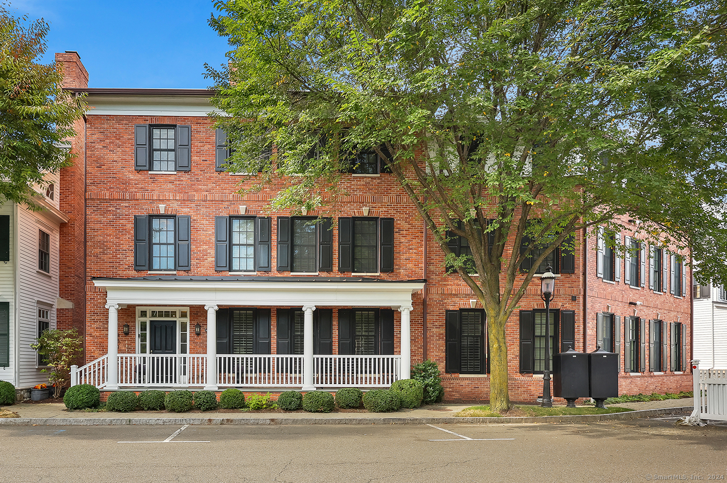 front view of a brick house with a yard