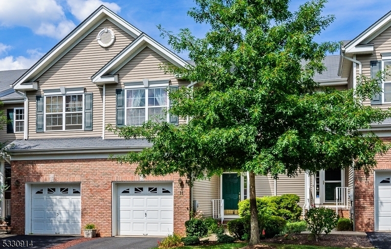 front view of a house with a tree