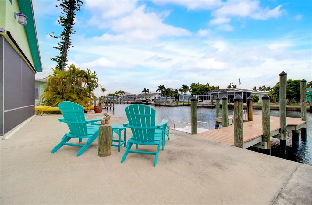 a view of a lake with a table and chairs