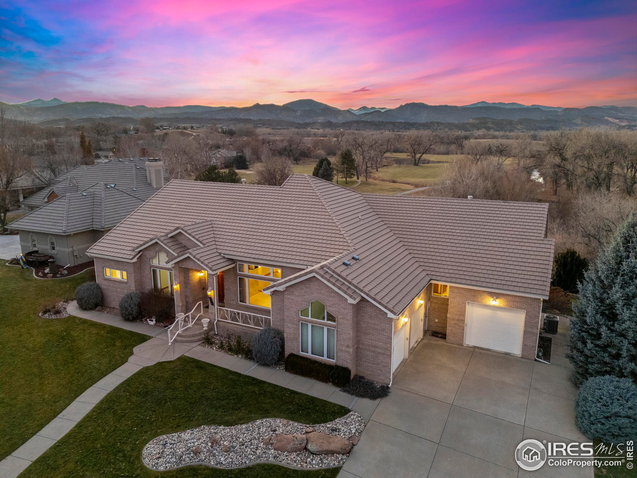 a aerial view of a house next to a yard