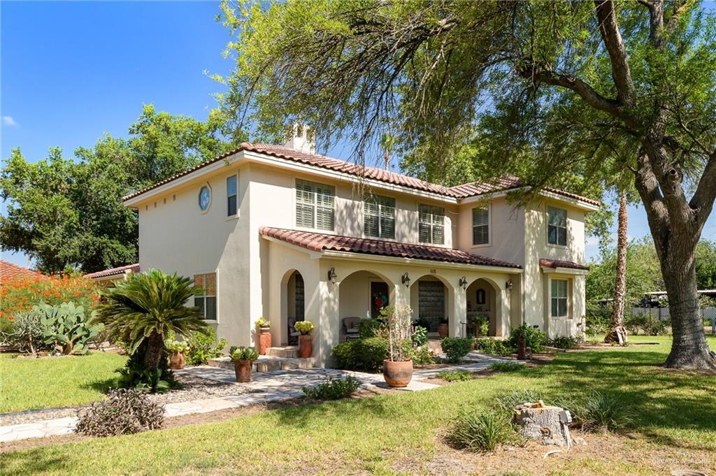 a view of a house with backyard porch and sitting area