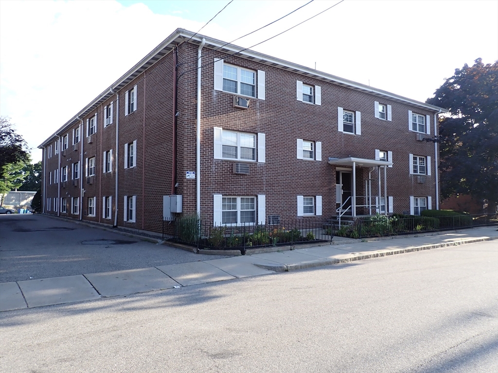 a front view of a building with a yard