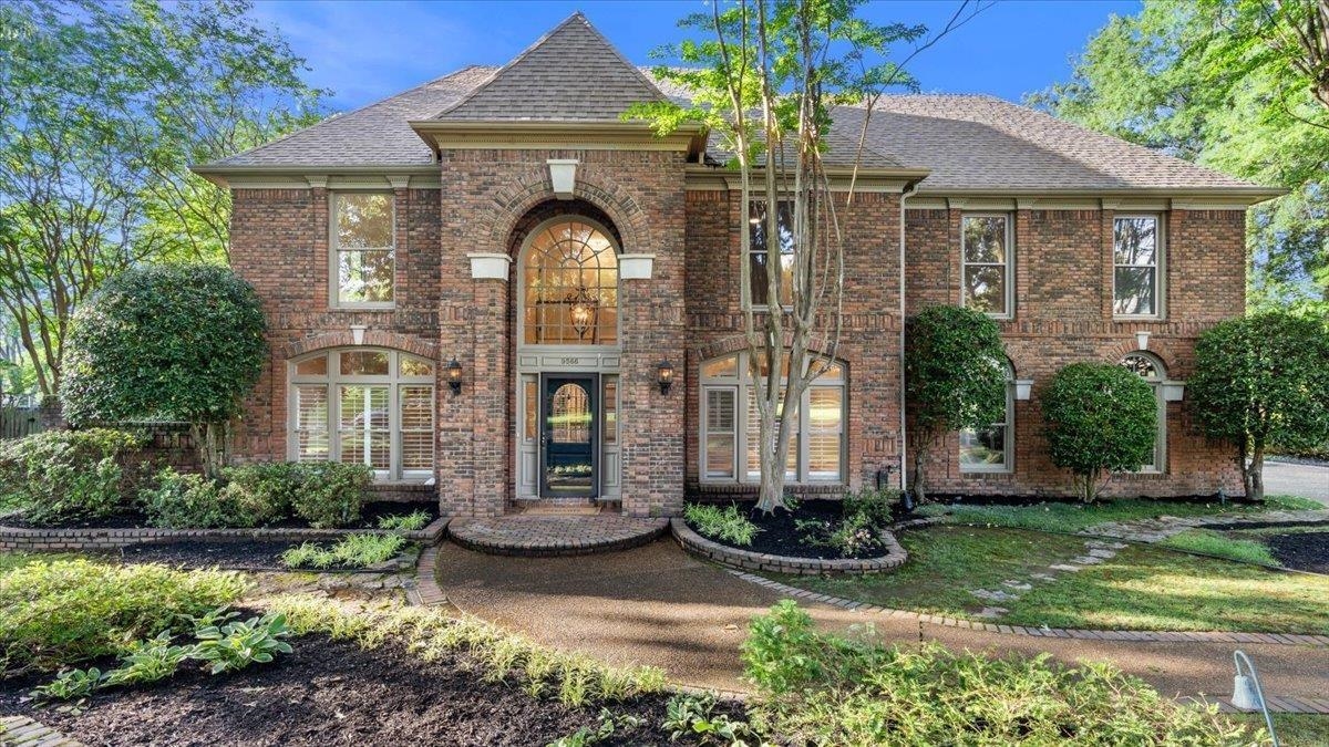 a front view of a house with garden