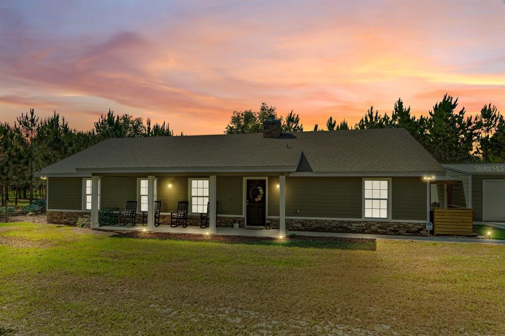 a front view of house with yard and outdoor seating