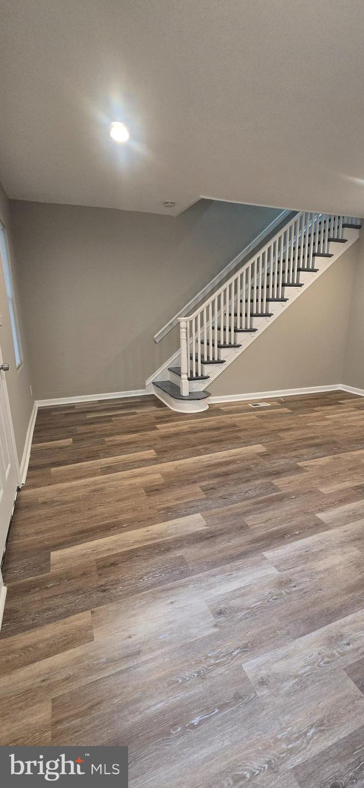 a view of a room with wooden floor