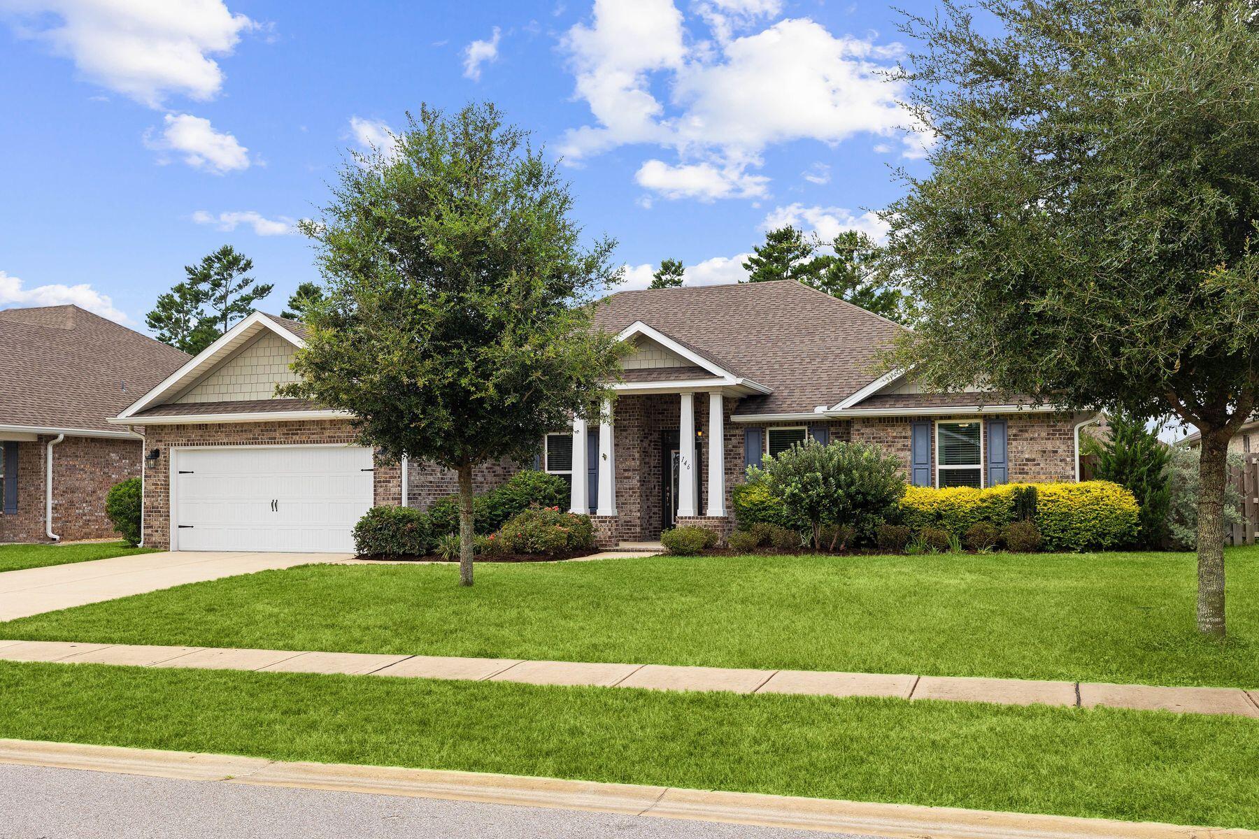 a front view of a house with a garden