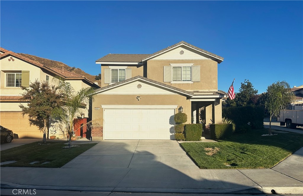 a front view of a house with a yard and garage