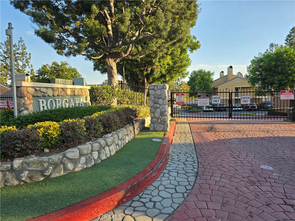 a view of street with houses and trees in the background