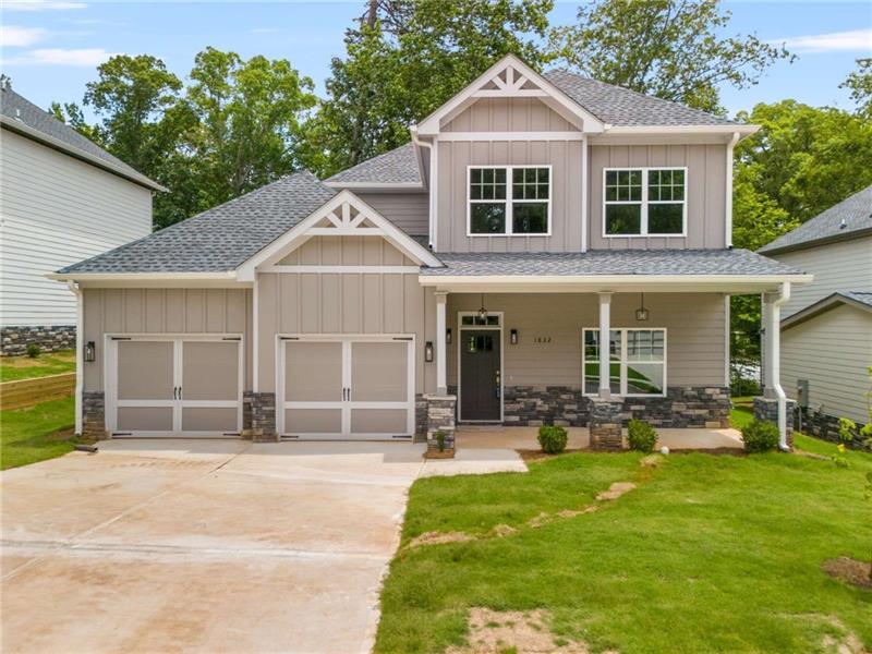 a front view of a house with a yard and porch