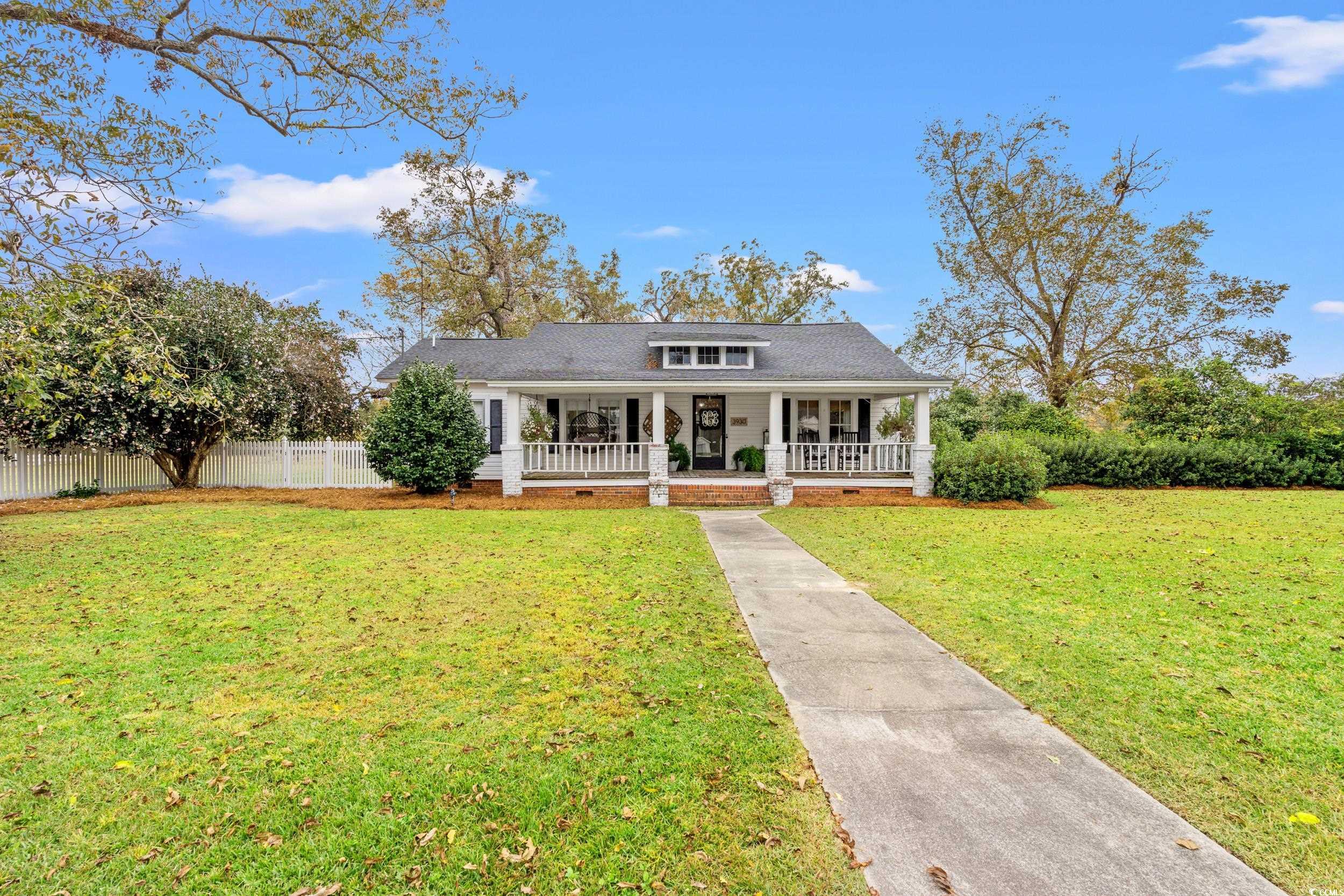 View of front of house with covered porch and a fr