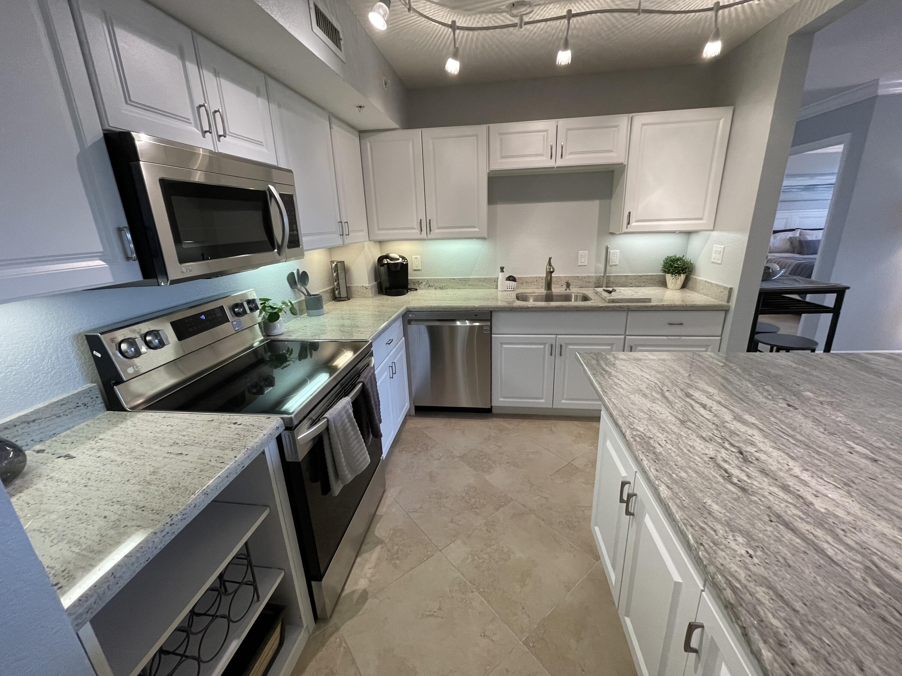 a kitchen with a stove sink and microwave