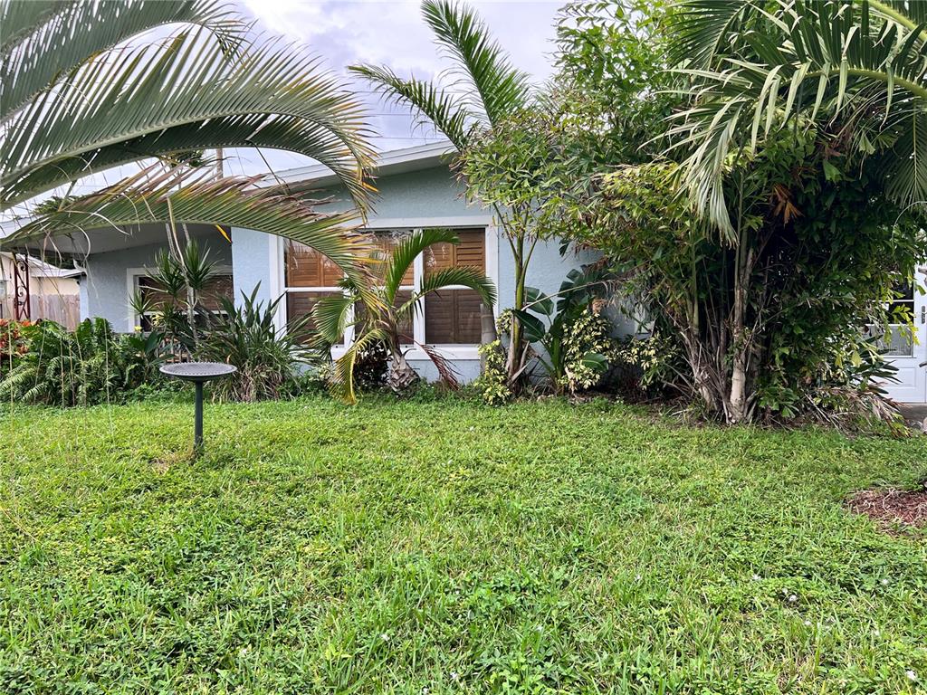 a view of a house with a yard and sitting area