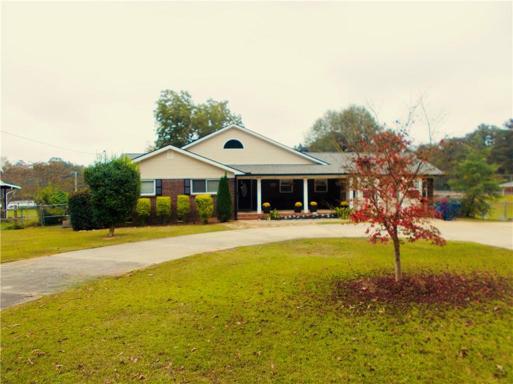 a front view of house with yard and swimming pool