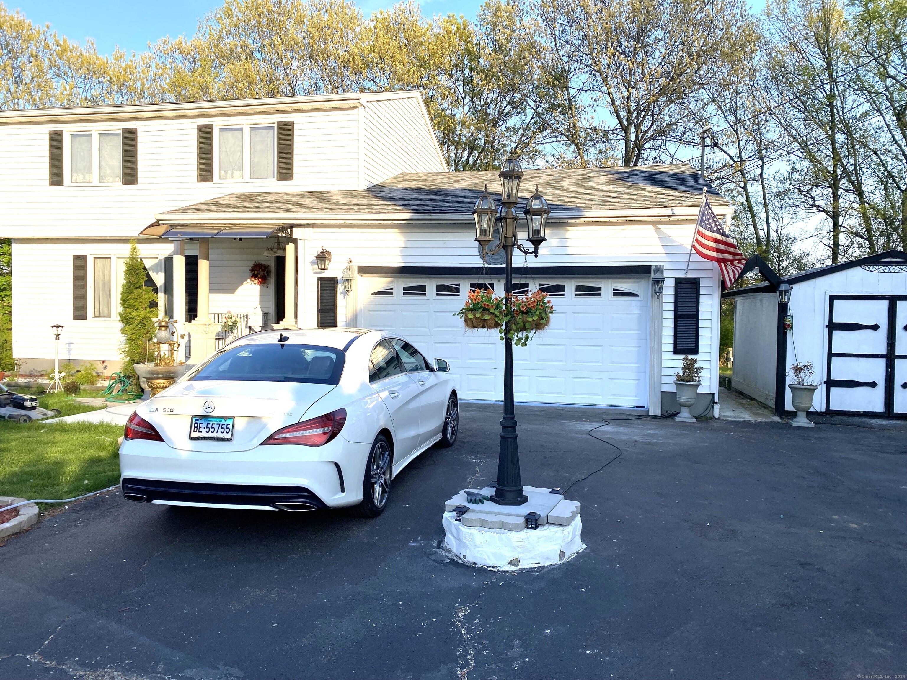 a front view of a house with a yard outdoor seating and garage