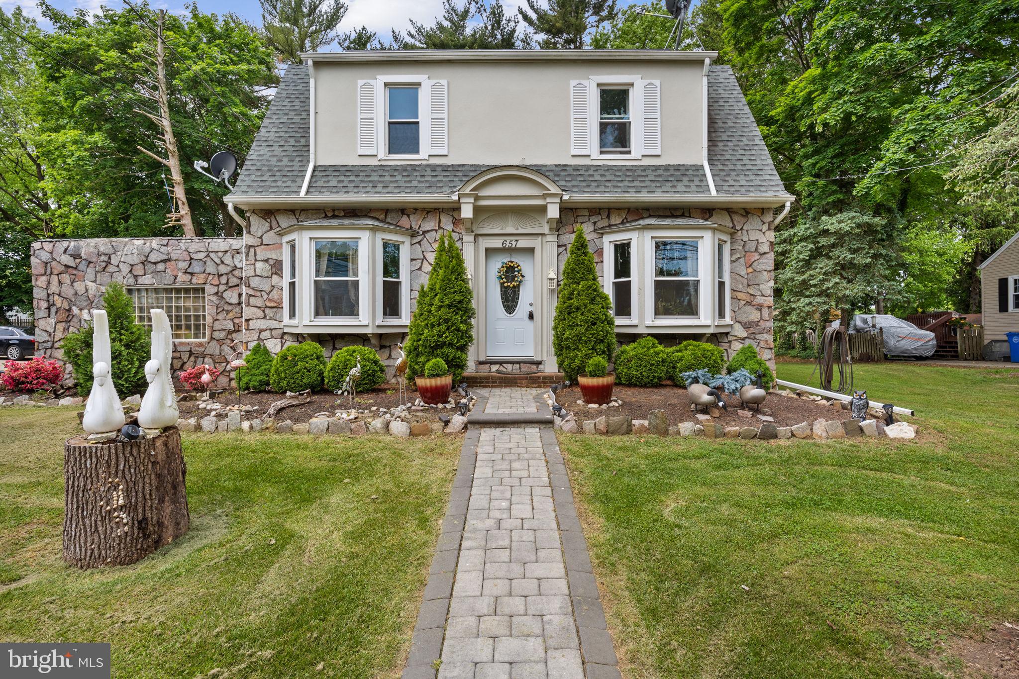 a front view of a house with garden