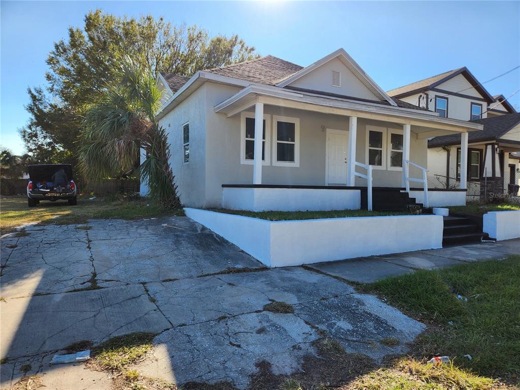 a front view of a house with a yard and outdoor seating