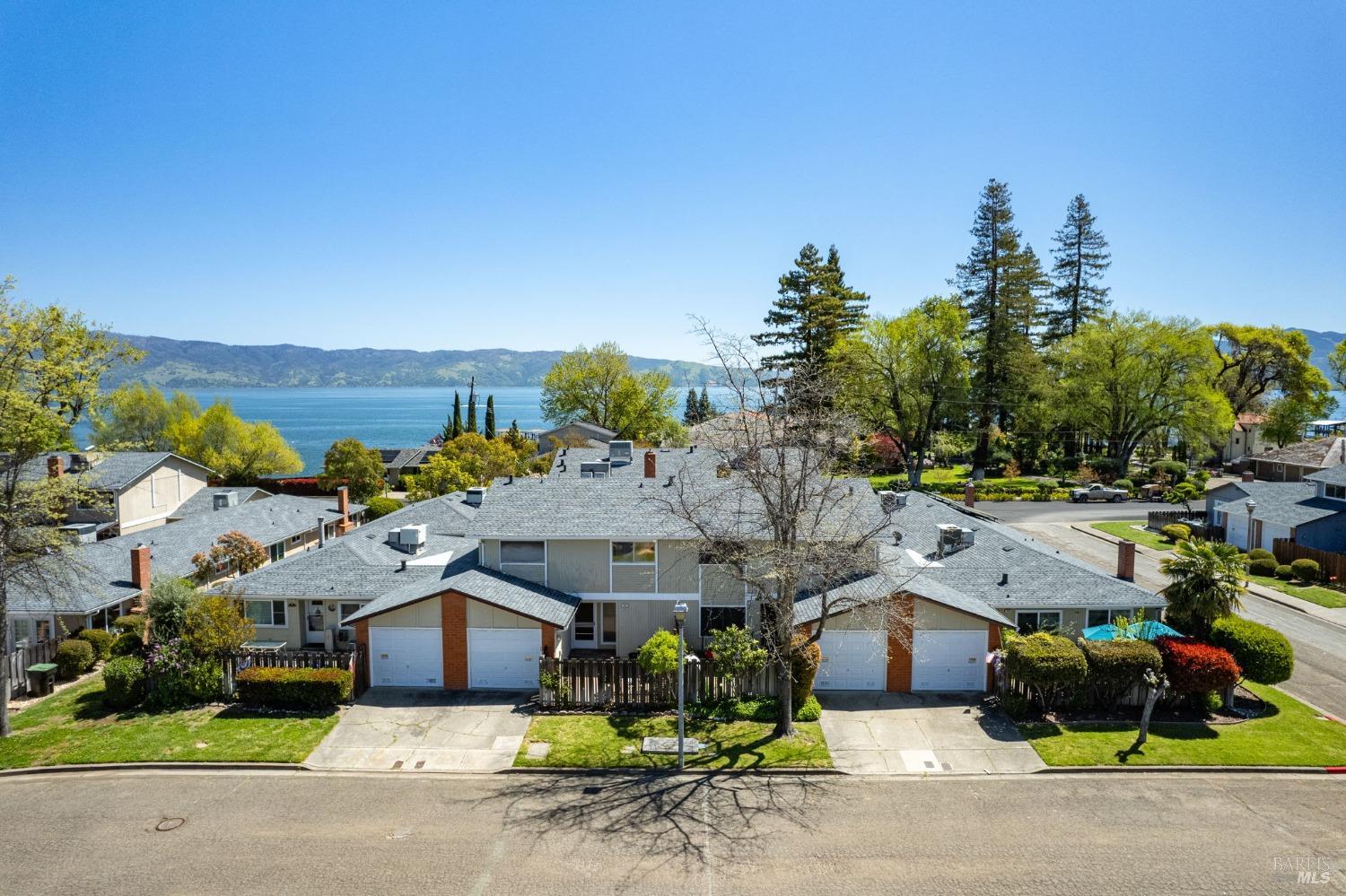 an aerial view of a house with a garden and mountain view