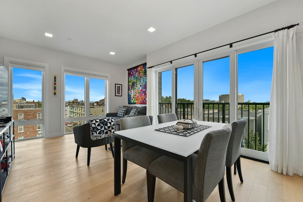 a view of a dining room with furniture window and wooden floor