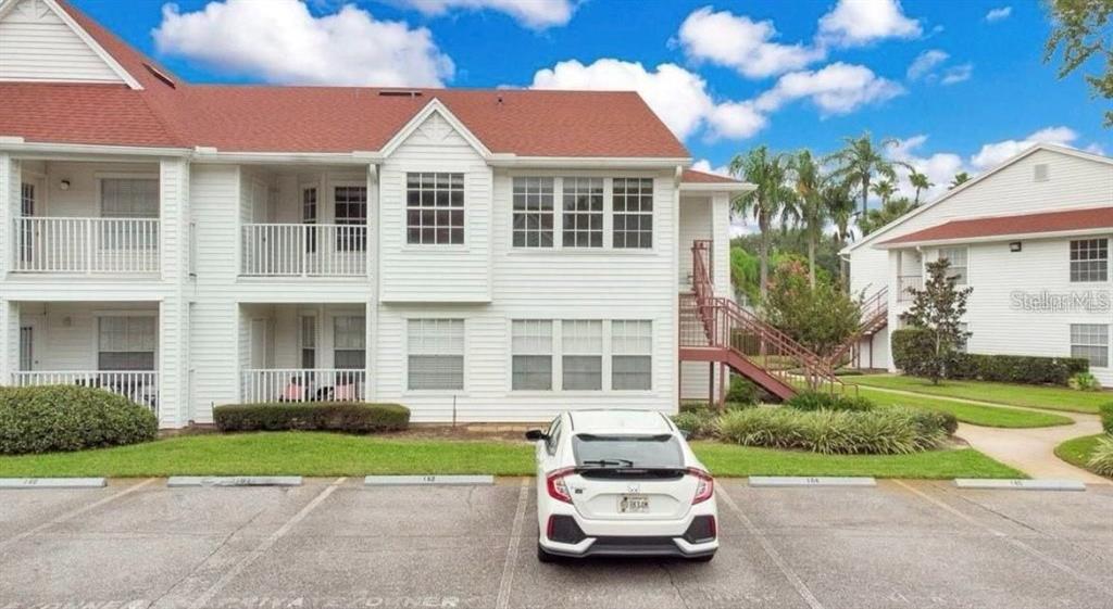 a car parked in front of a house with a yard