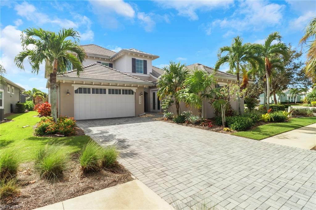 Mediterranean / spanish home with a front lawn and a garage