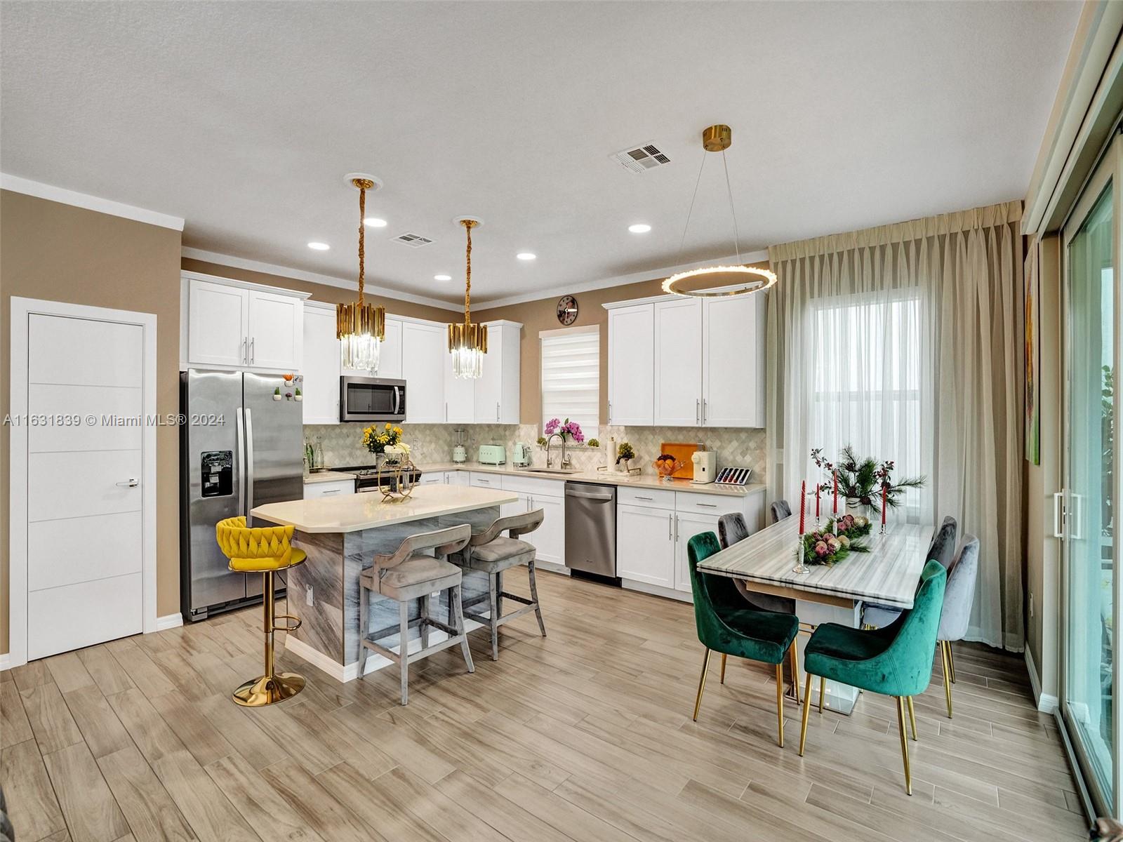 a kitchen with a table chairs and a refrigerator