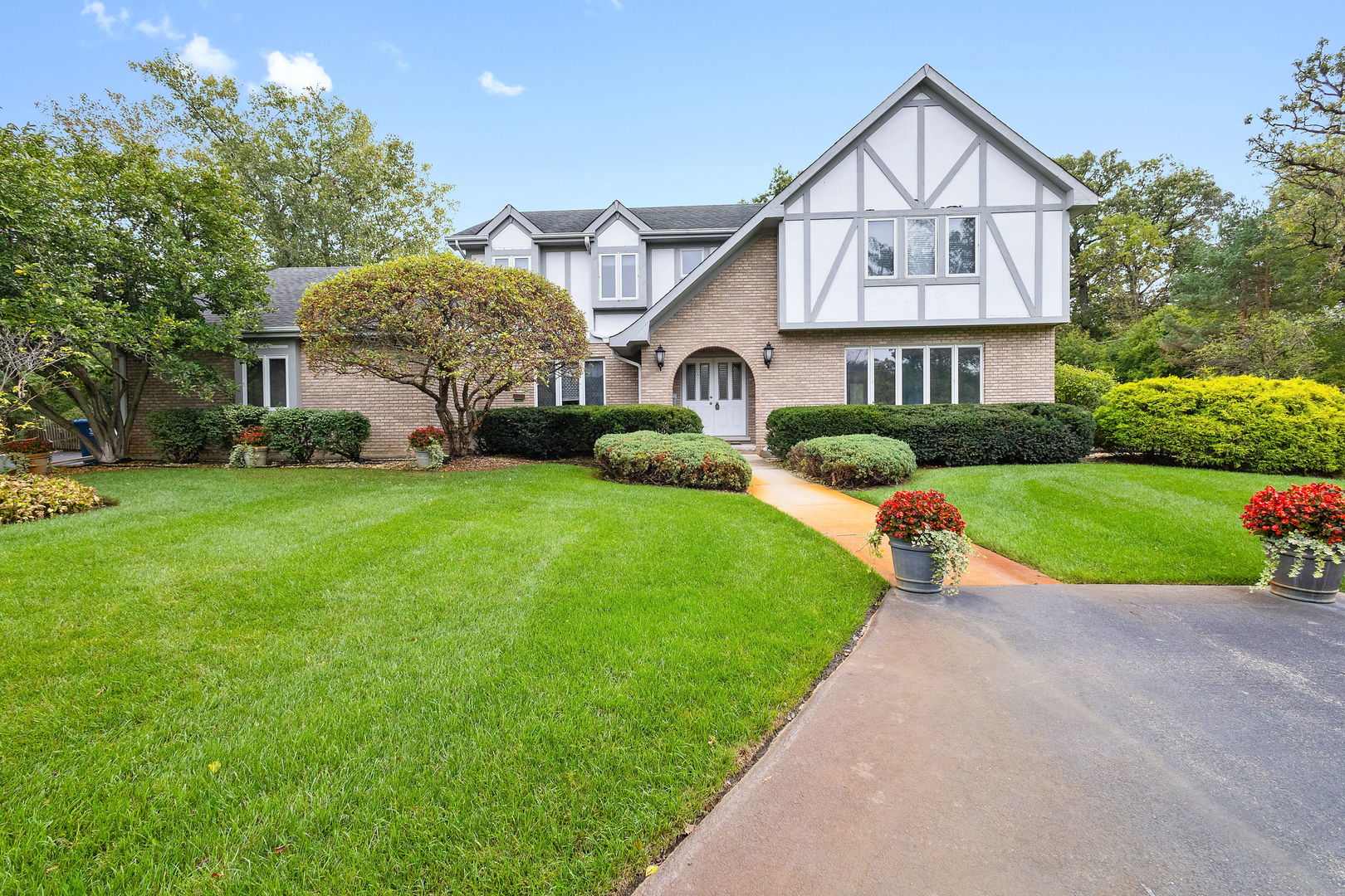 a front view of house with yard and green space