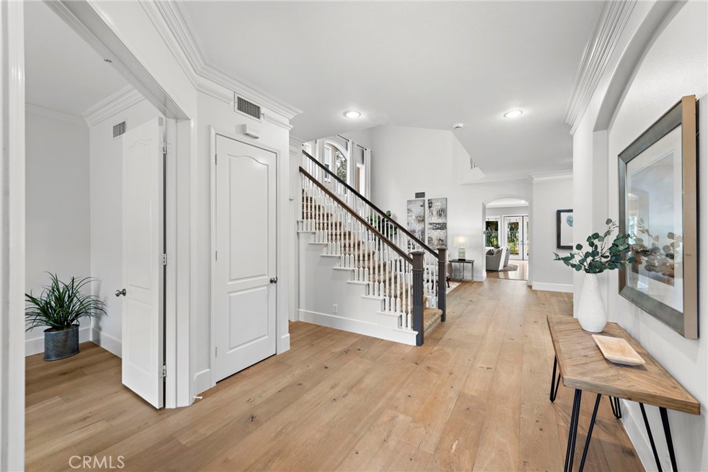 a view of entryway and hall with wooden floor