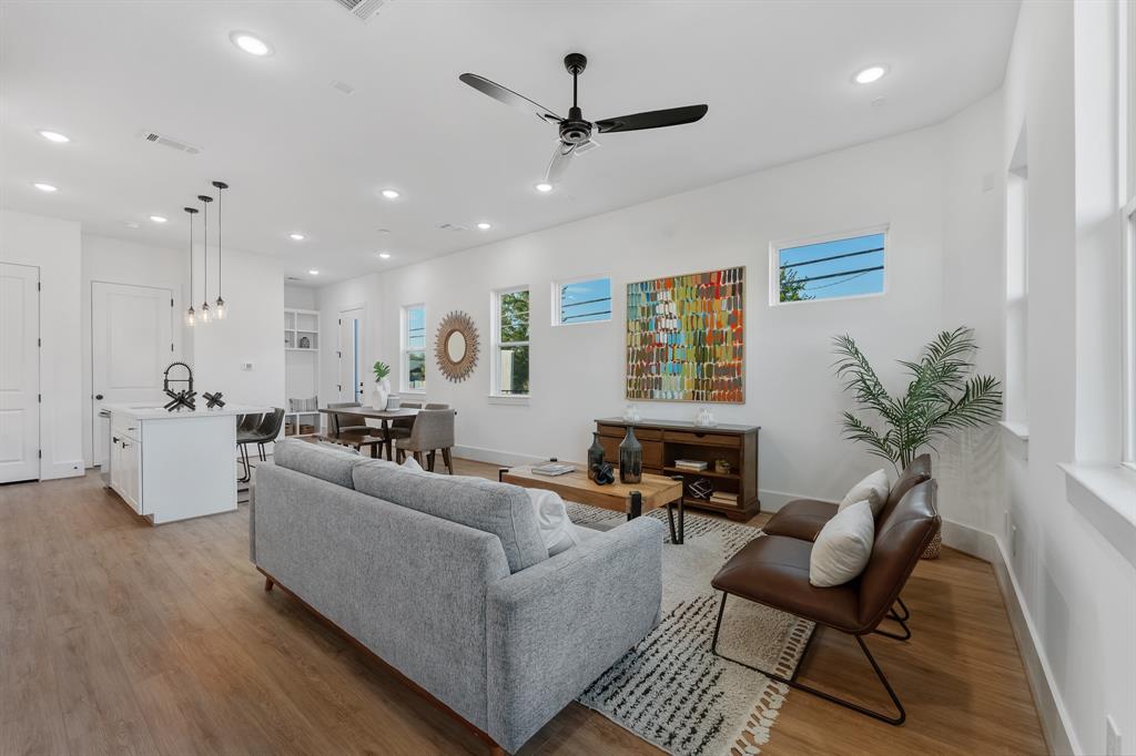 a living room with furniture and a ceiling fan