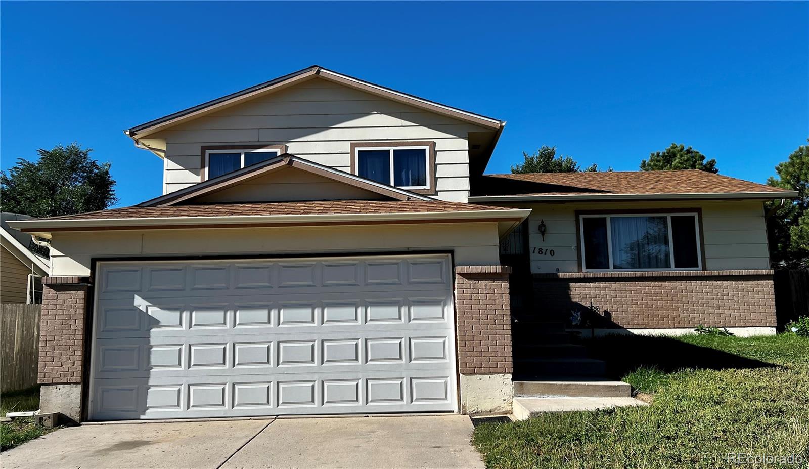 a front view of a house with a garage