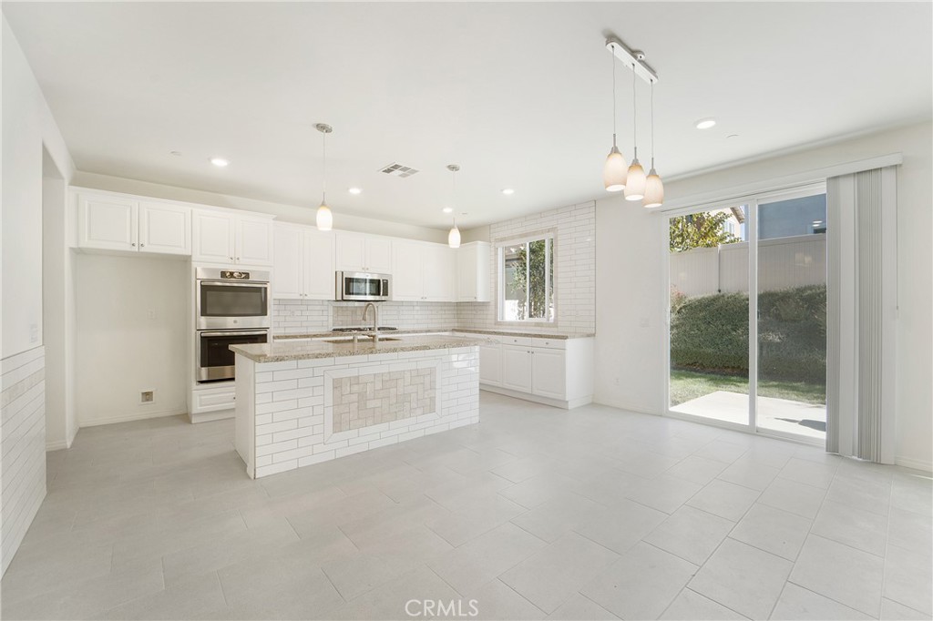 Light and bright, highly upgraded kitchen over looks beautiful & fully landscaped back yard.