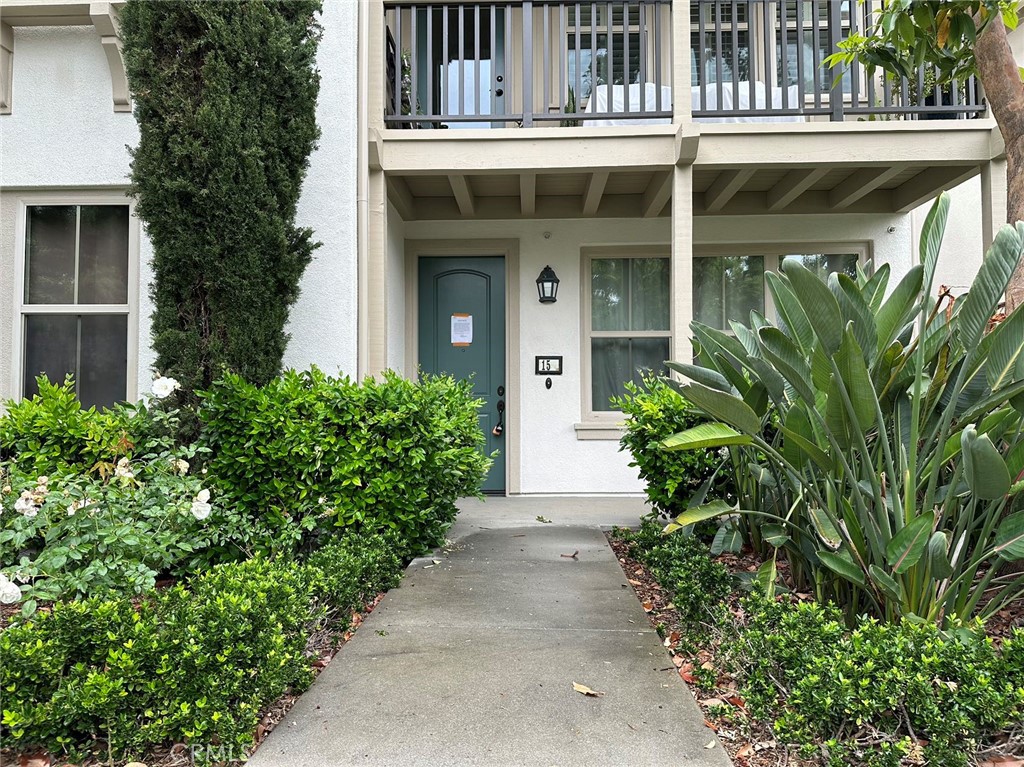 a front view of a house with plants