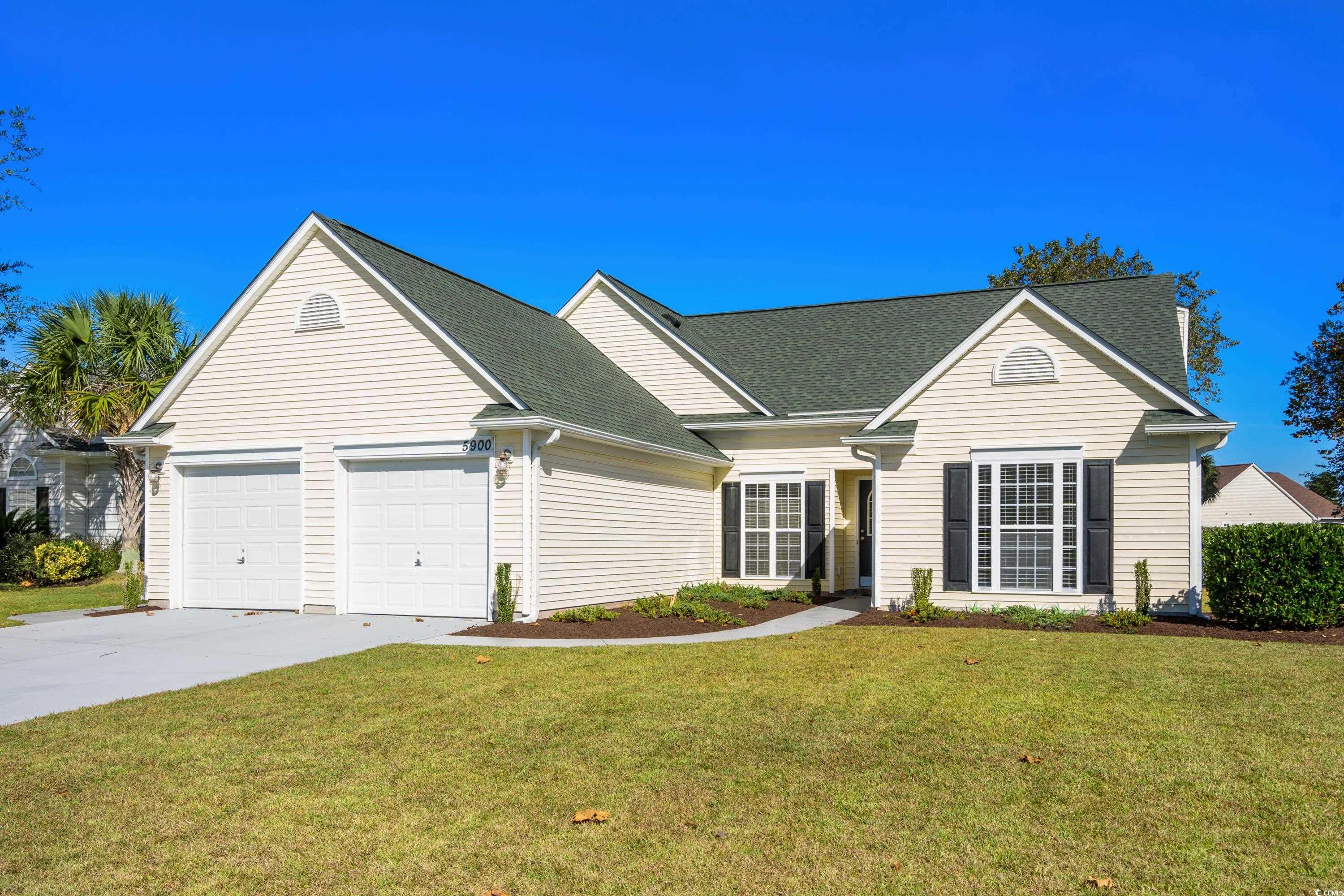 Ranch-style house featuring a garage and a front l