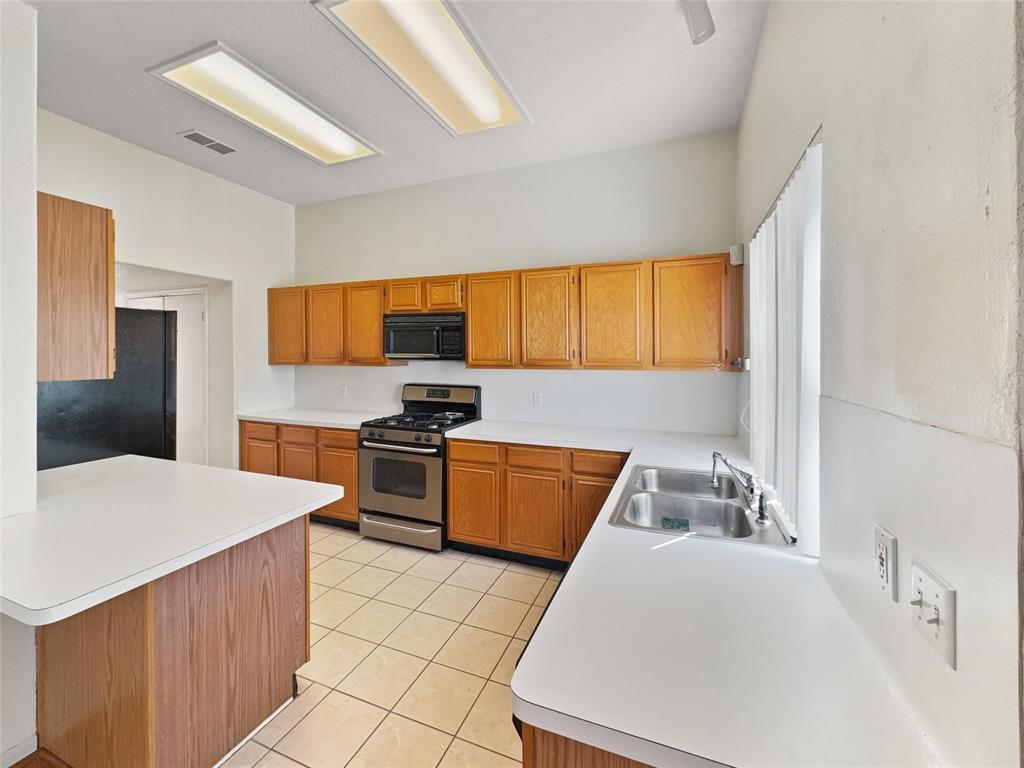 a kitchen with a stove a sink and a refrigerator