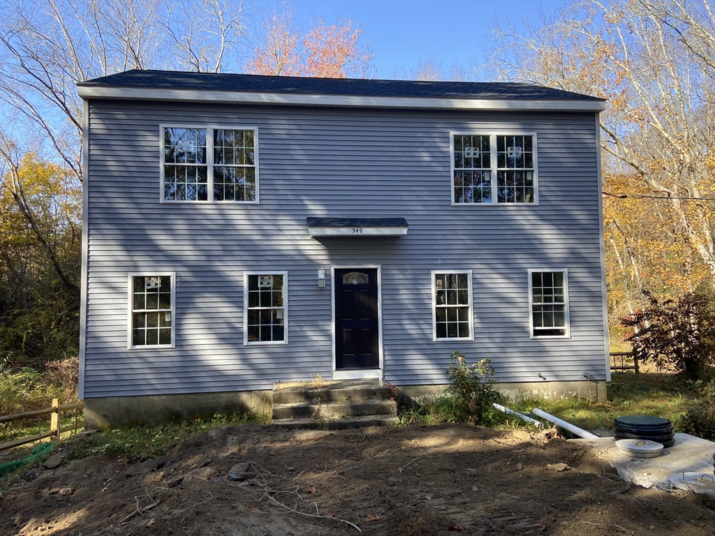 a front view of a house with a yard