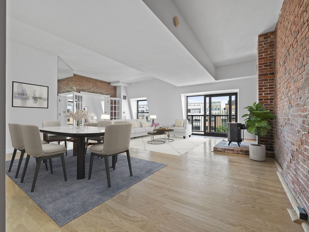 a view of a dining room with furniture and a potted plant