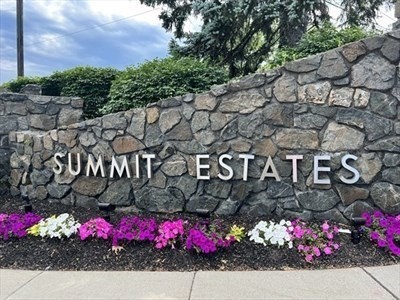 a street sign that is covered with tall trees