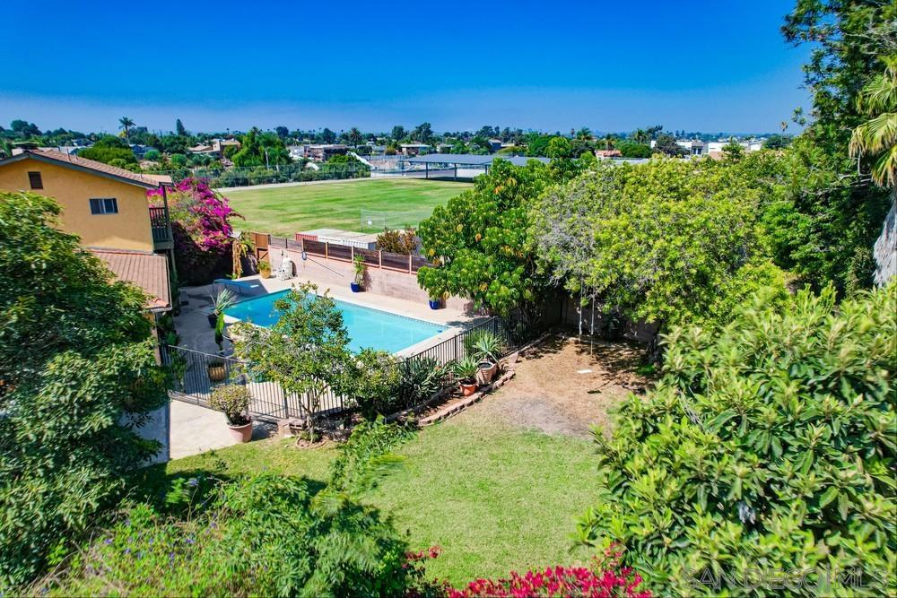 an aerial view of a house with a yard basket ball court and outdoor seating