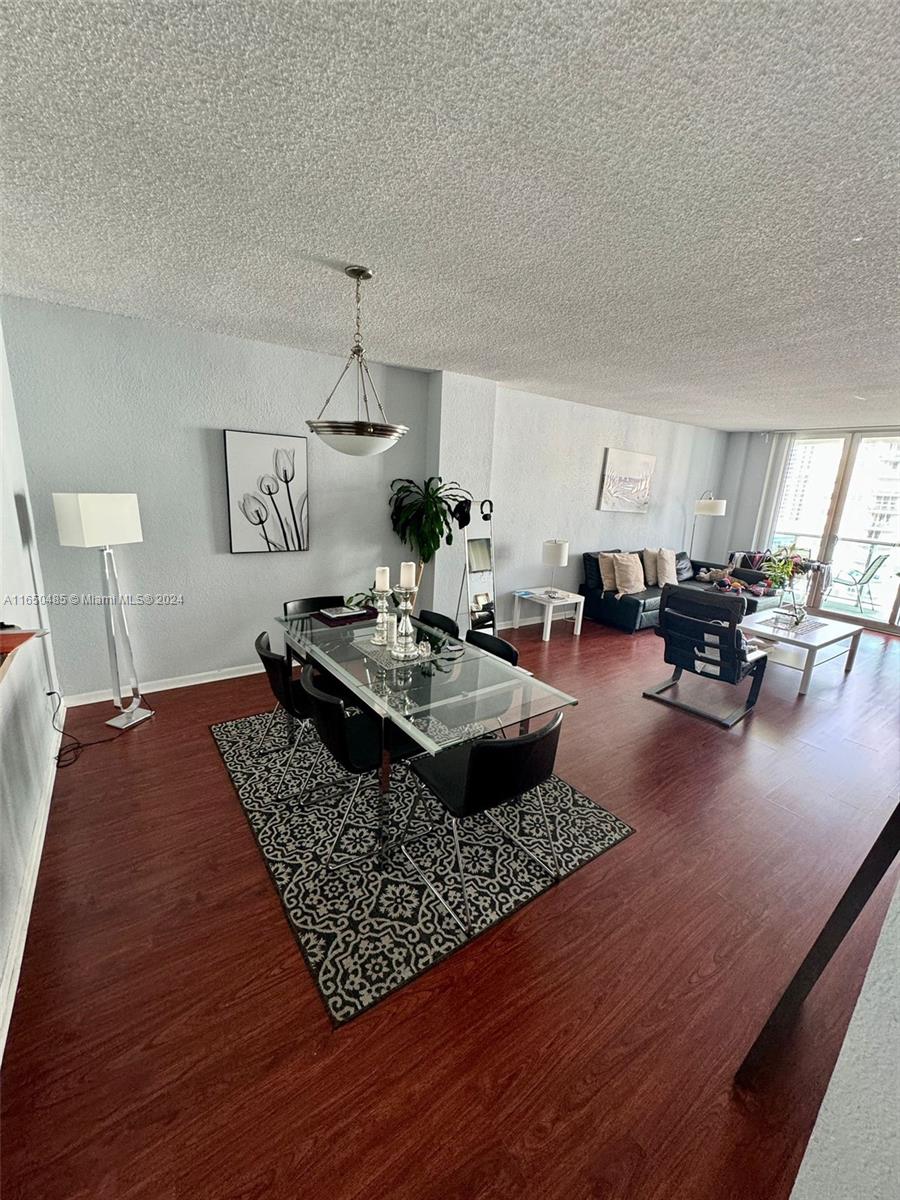 a living room with a couch and kitchen view