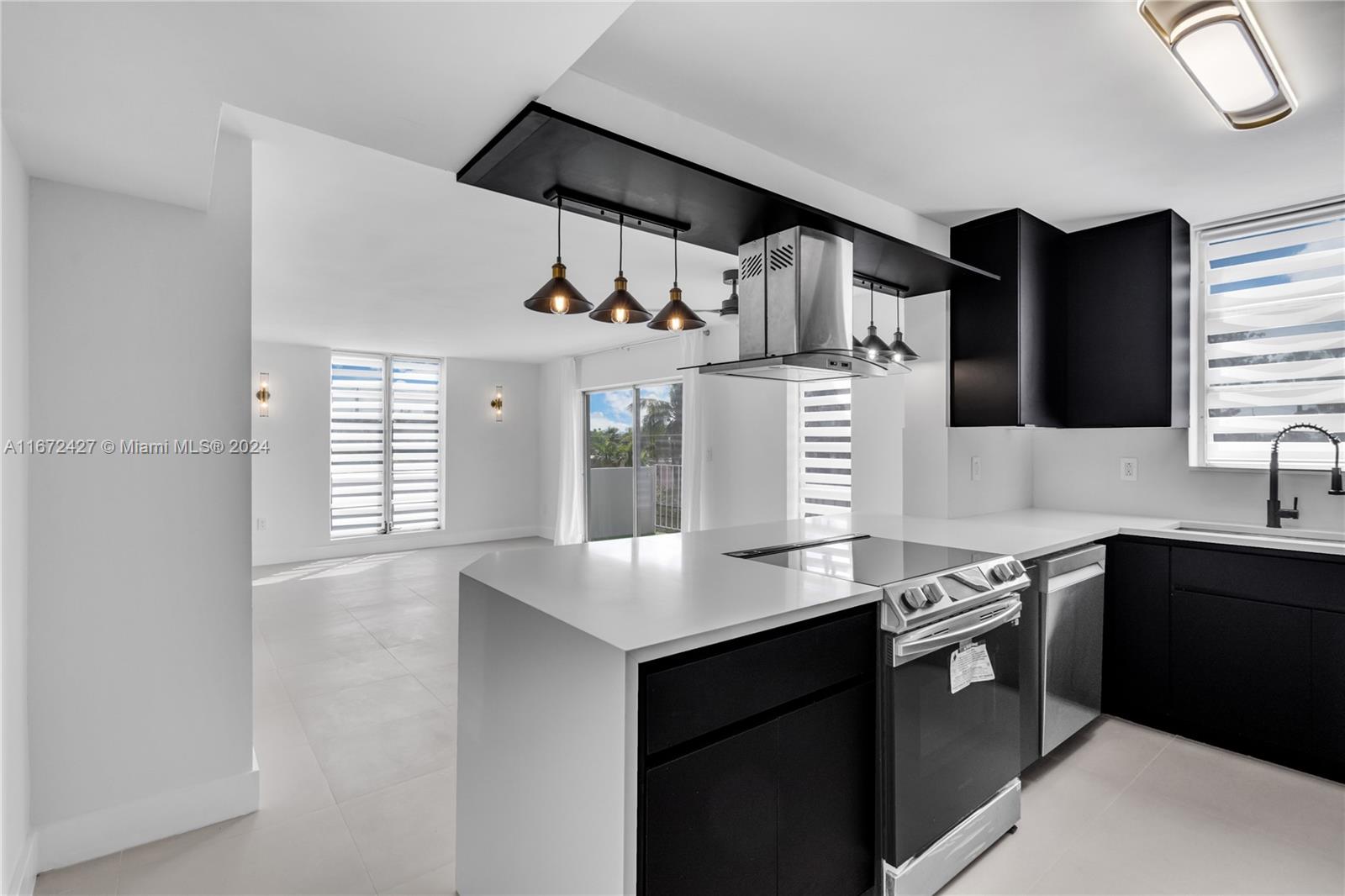 a kitchen with stainless steel appliances granite countertop a sink and a stove