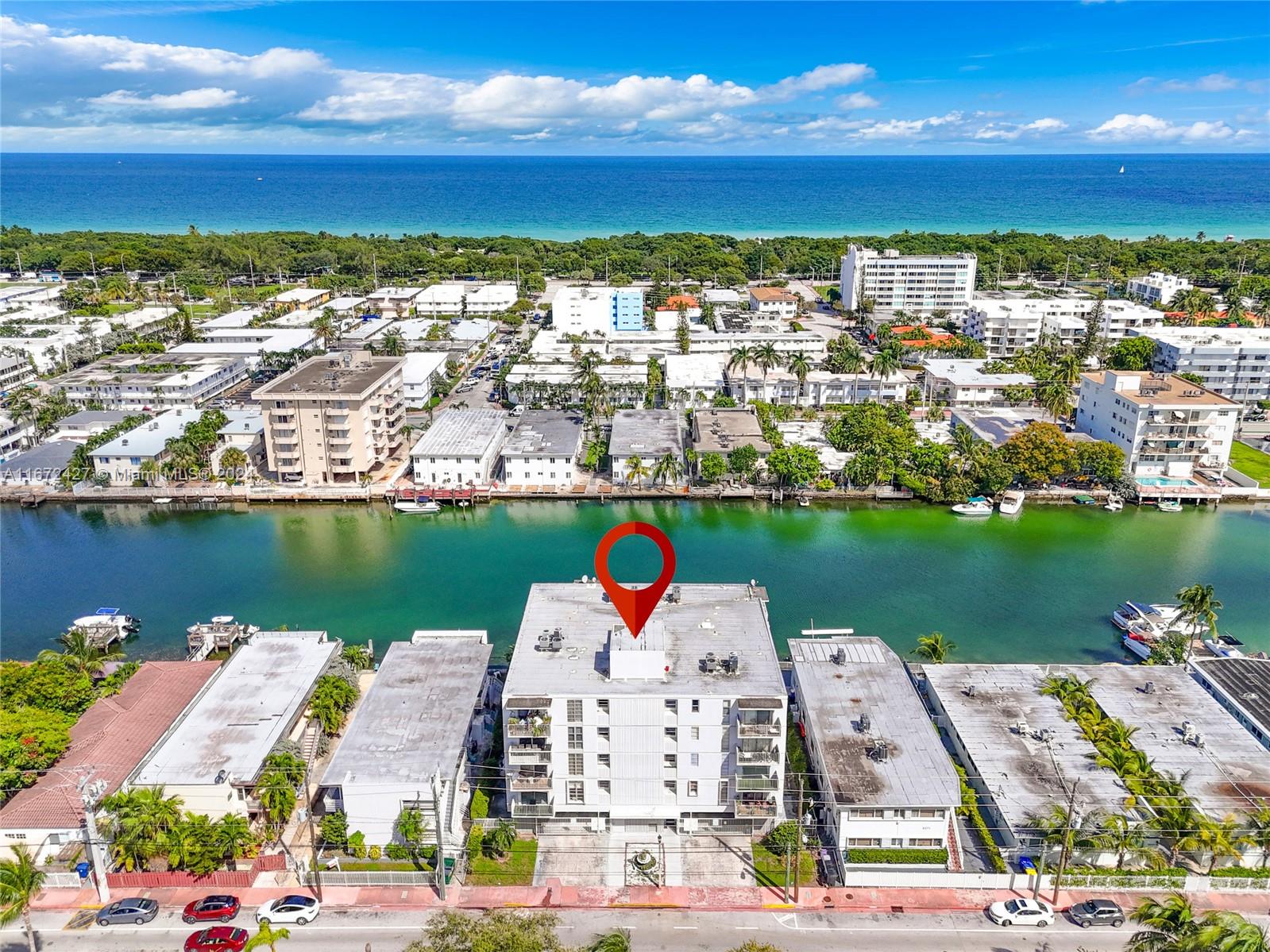 an aerial view of residential houses with outdoor space and lake view