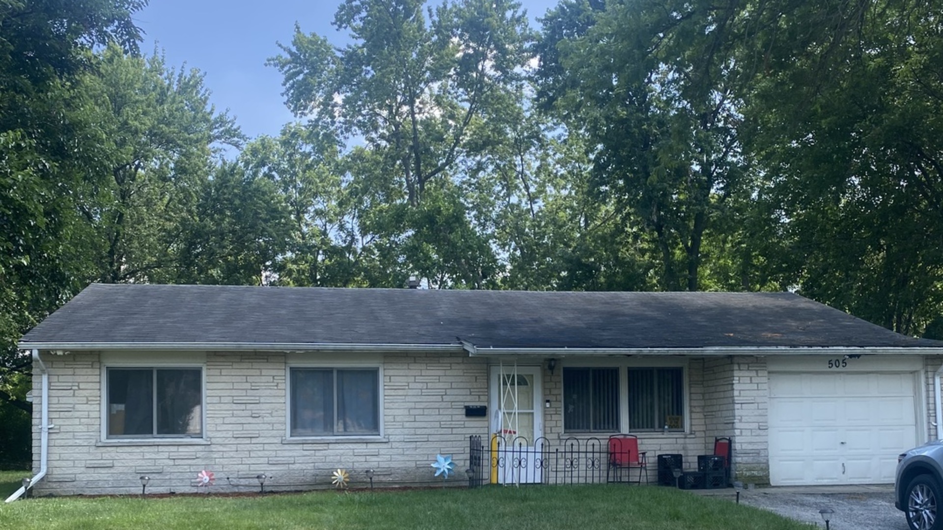 a view of a house with a garden and tree