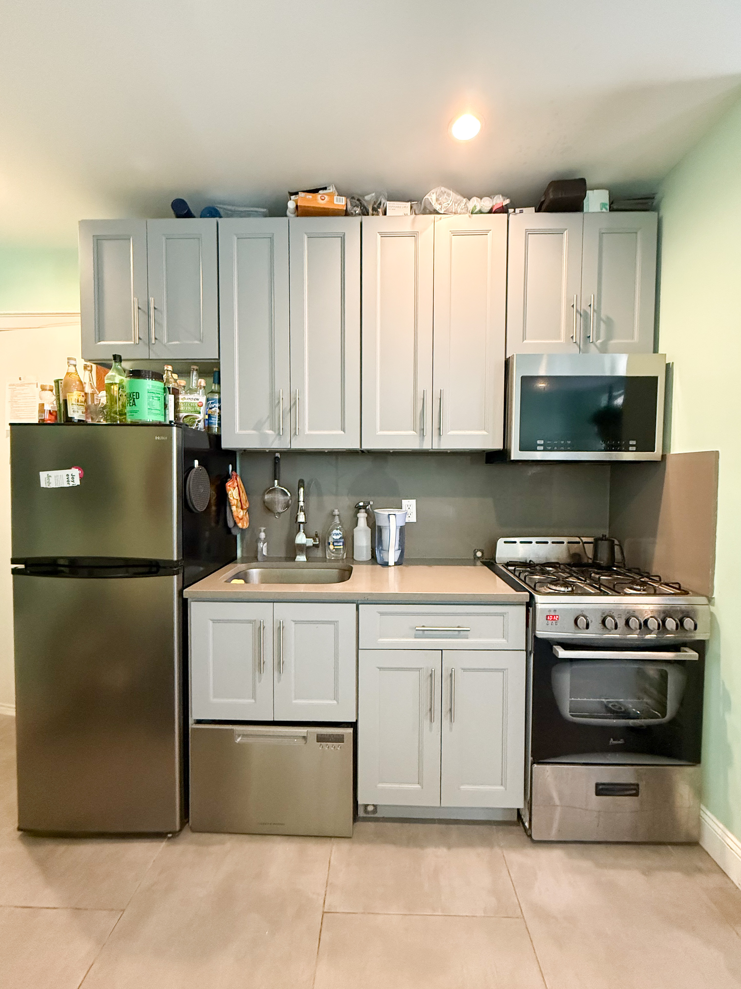 a kitchen with a stove a refrigerator and a sink