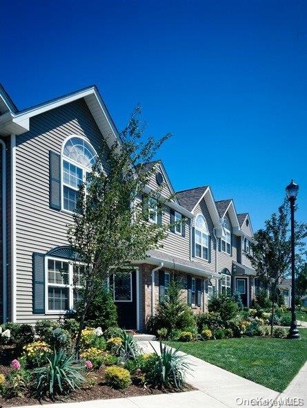 a front view of a house with a garden