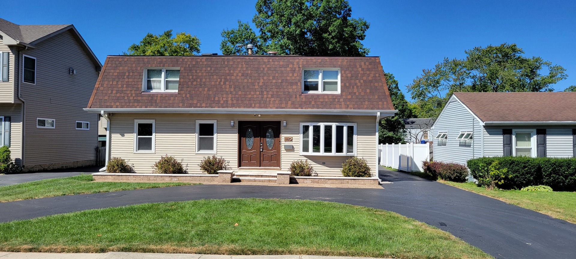 a front view of a house with a yard