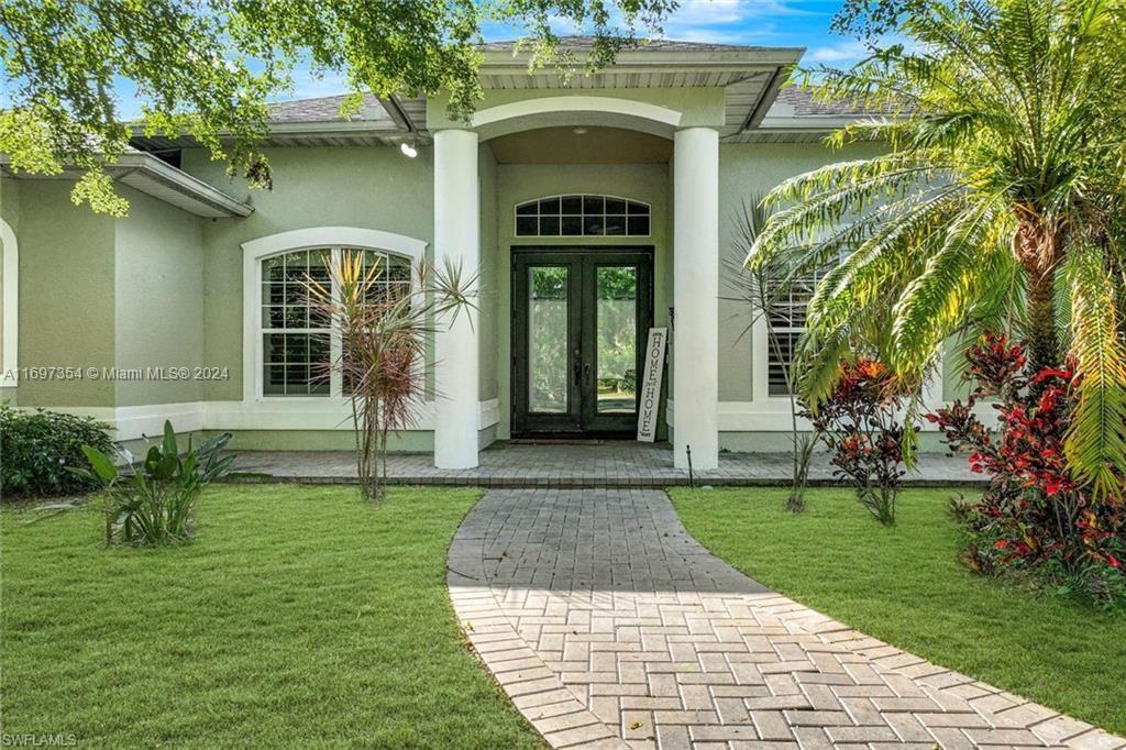 a front view of a house with garden