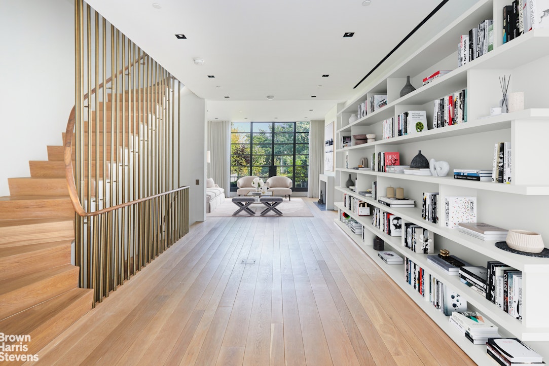 a living room with furniture and a book shelf