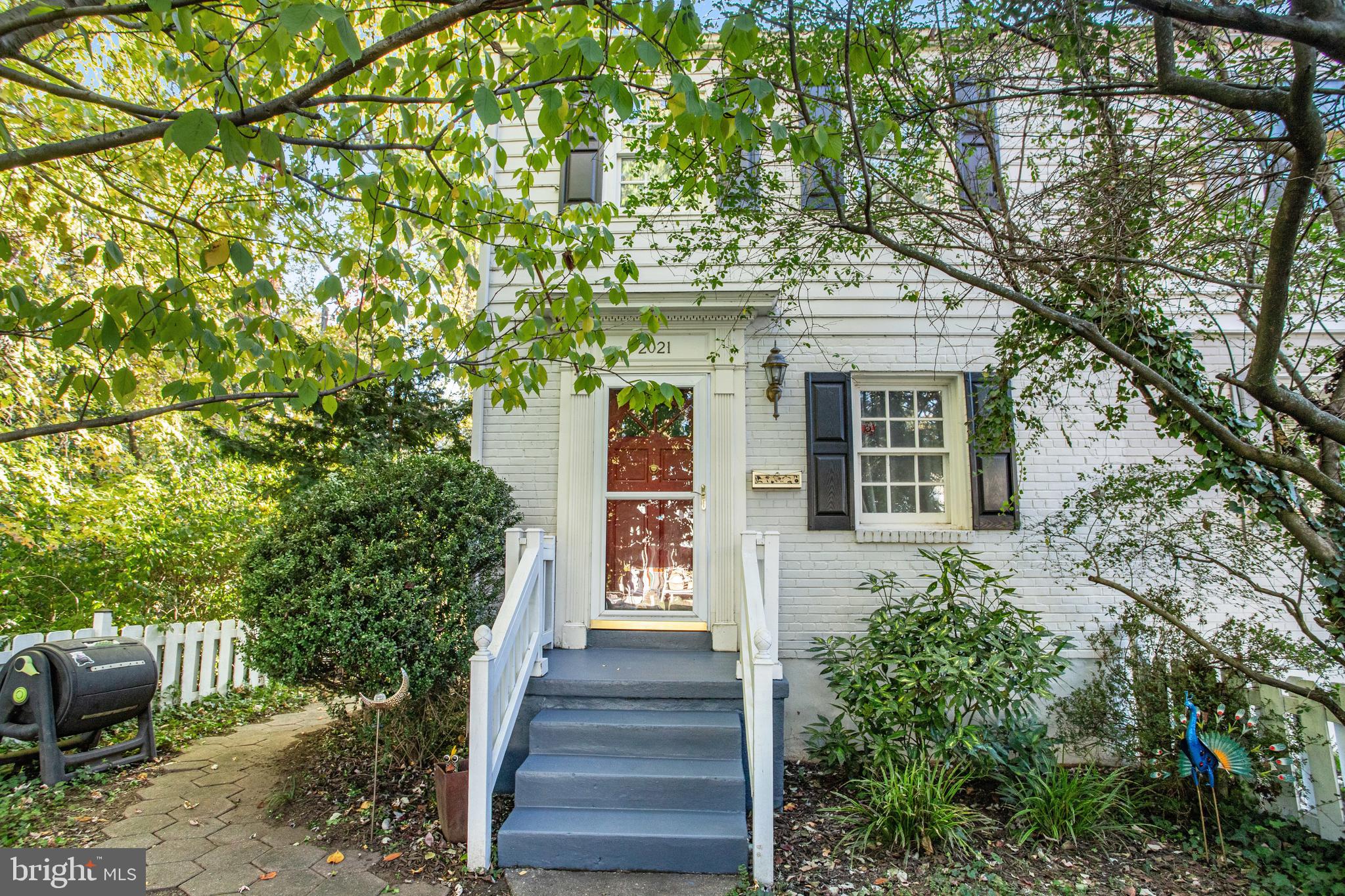 a front view of a house with stairs plants