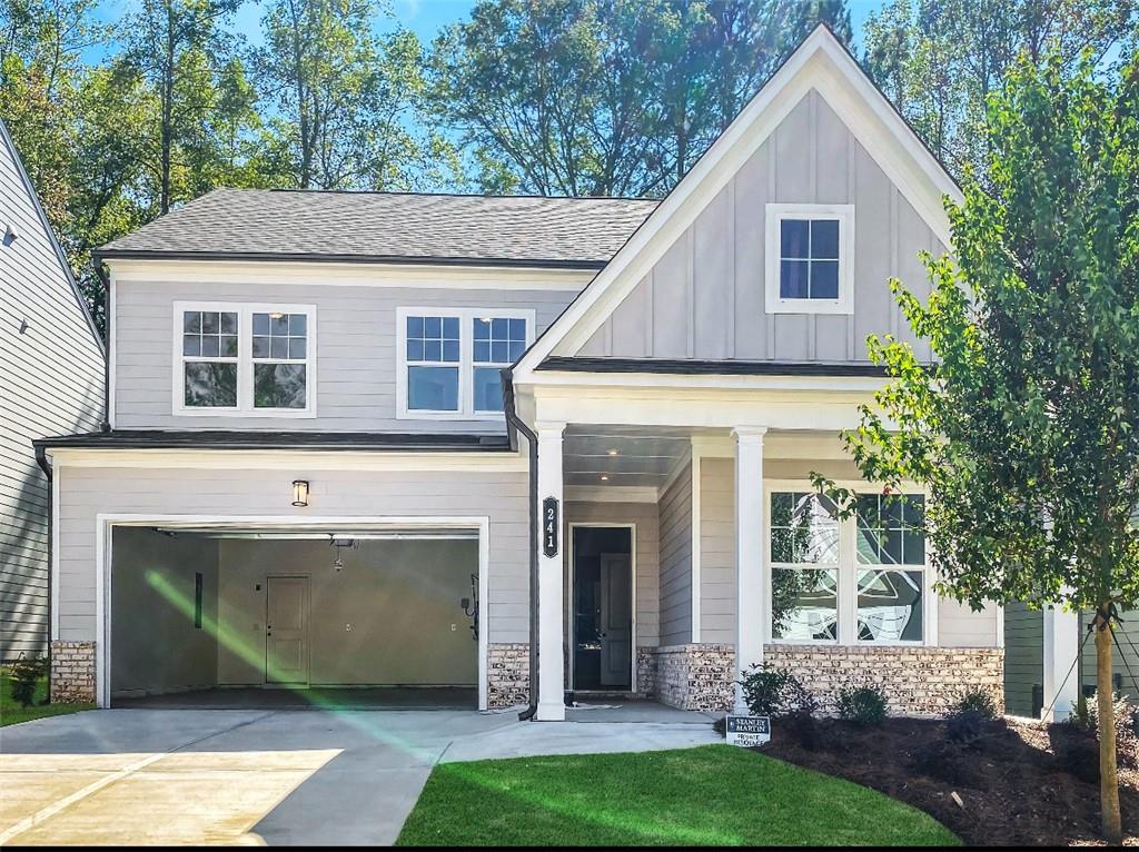 a front view of a house with a garden and yard